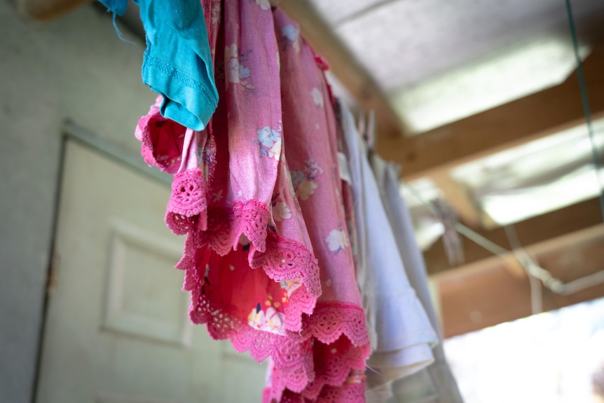 A photo of clothes hanging to dry outside.