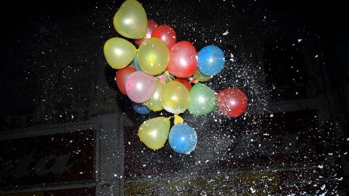 Pakistani men release balloons to celebrate New Year's Eve in Lahore