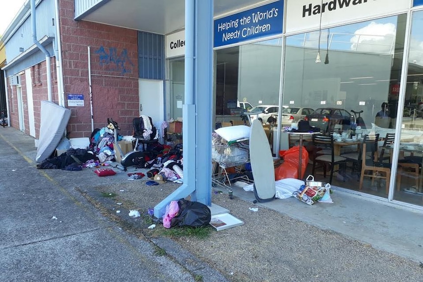 A pile of clothes and household goods outside a charity shop