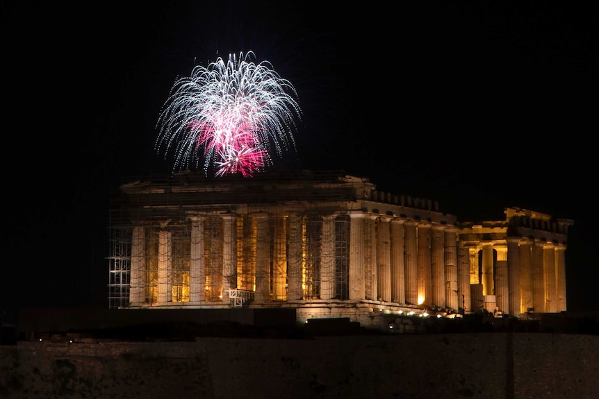 Pink and white fireworks over the Parthenon temple.