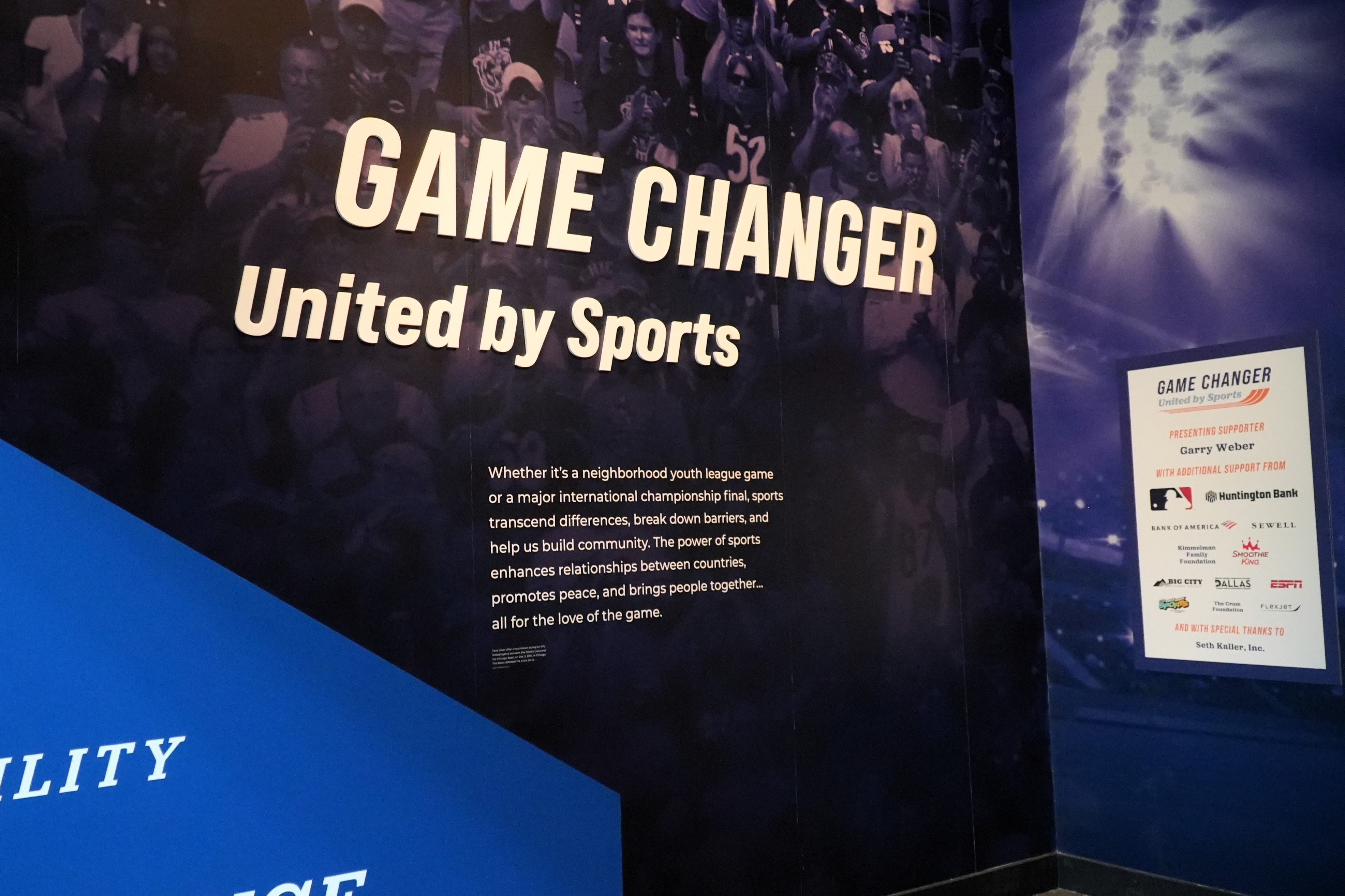 A museum exhibition sign which says 'Game Changer, United by Sports'
