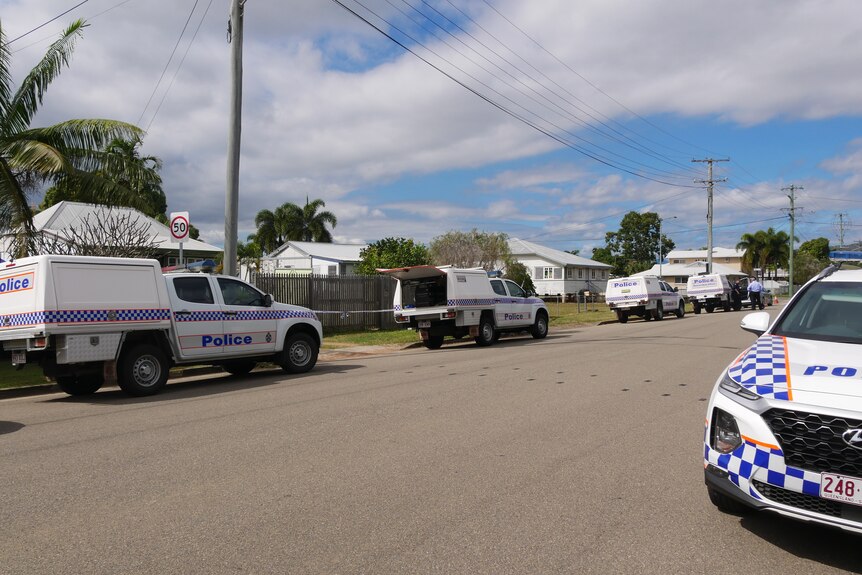 At least five police vehicles line a street in the Townsville suburb of Mundingburra