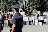 Protestors hold signs against fracking and unconventional gas mining