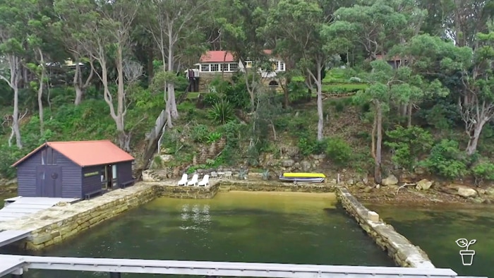 House on a waterfront with a boathouse and jetty.