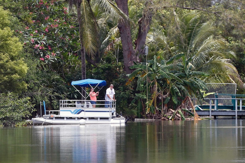 A couple looks out from a pontoon boat on one of the lakes at Silver Lakes Rotary Nature Park.