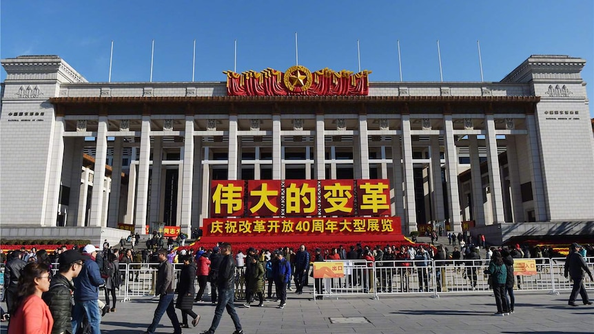 China's national museum on tiananmen square where people were walking around.