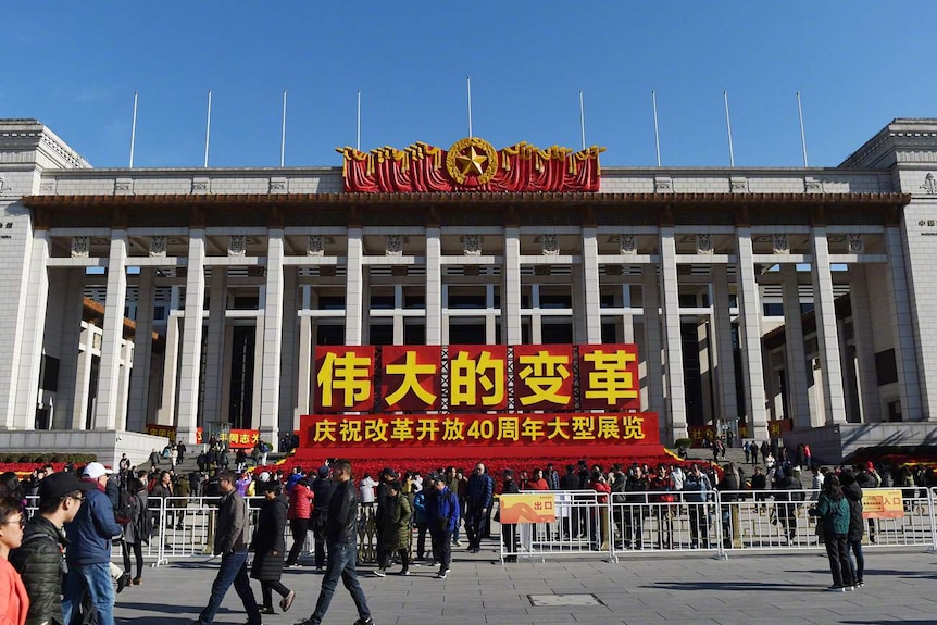 China's national museum on tiananmen square where people were walking around.