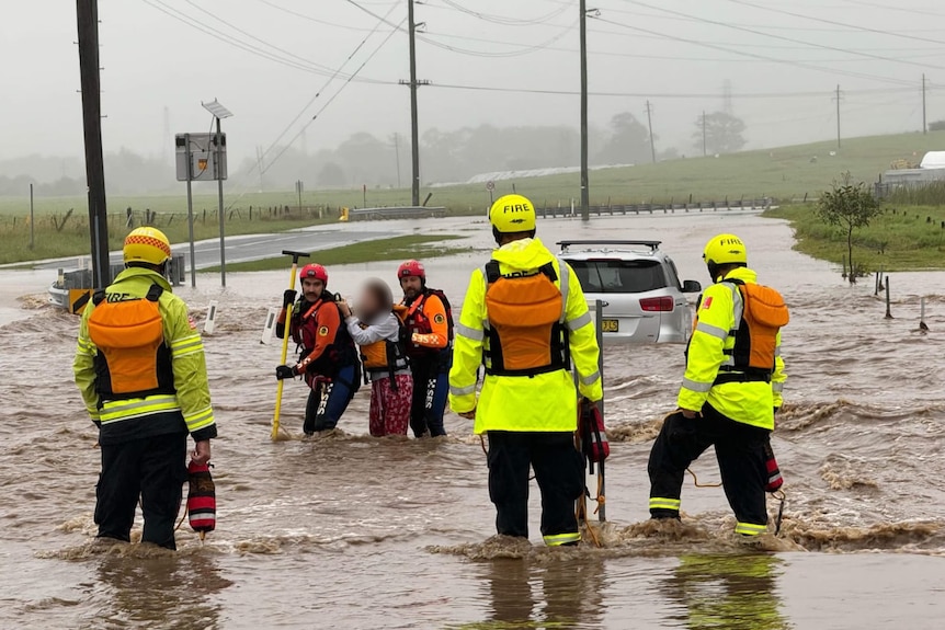 state emergency service peonnell rescue a woman from a sinking car