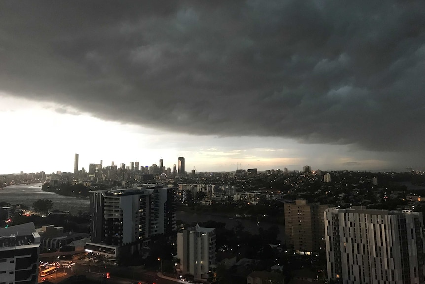 Dark storm crowds moving across the sky towards Brisbane city