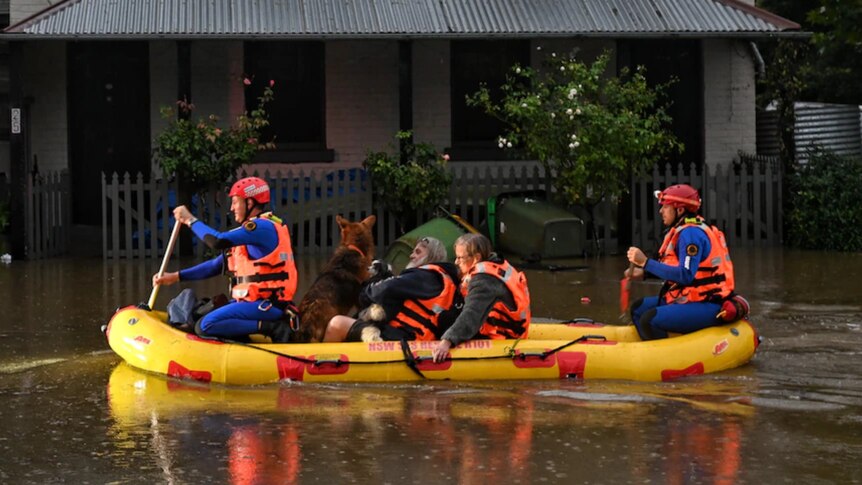 A bright rescue boat carries Lismore residents to safety as floodwaters rise.