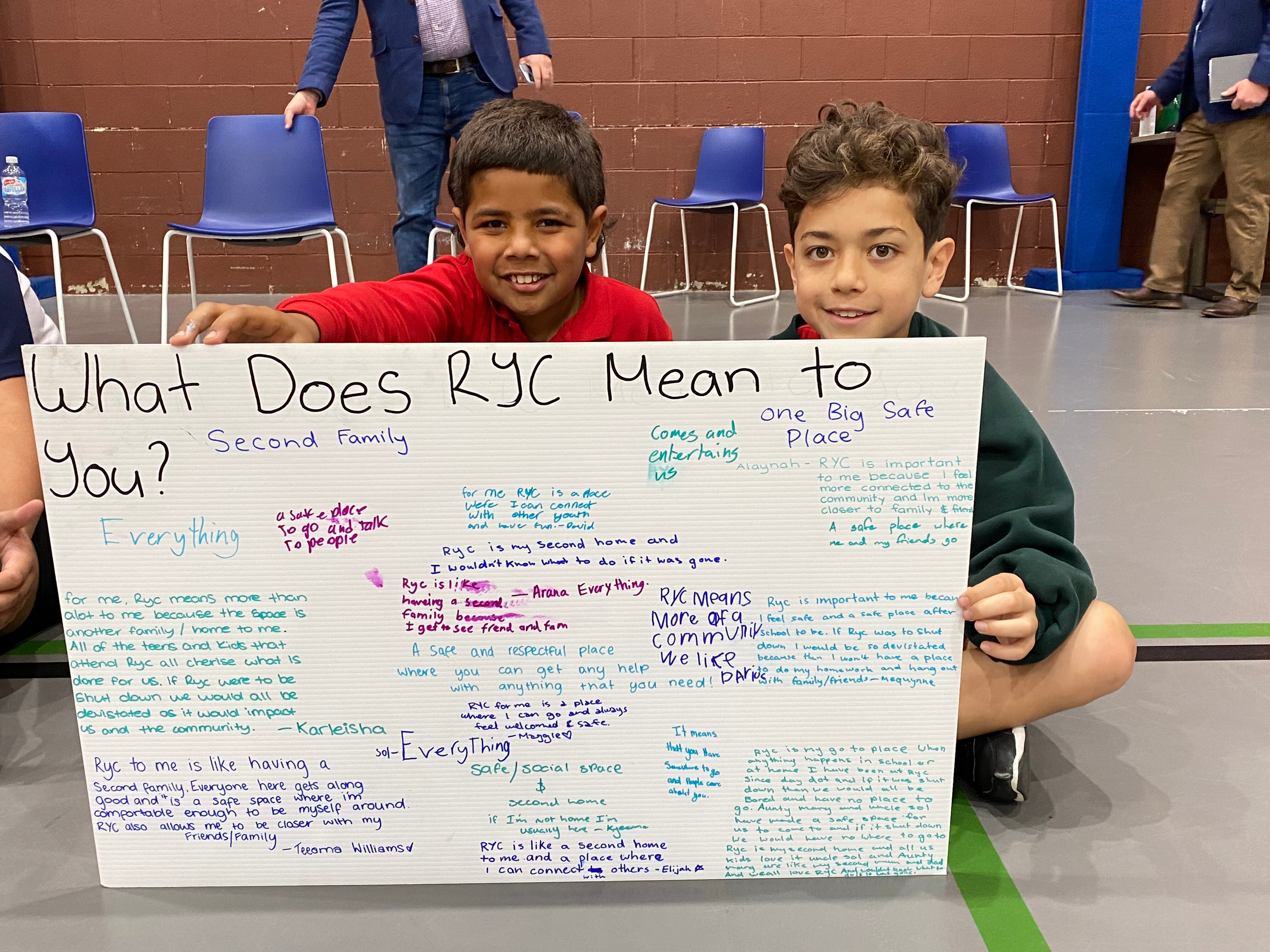Children hold a sign that reads 'What Does RYC Mean To You?'  at the National Center for Indigenous Excellence in Redfern 