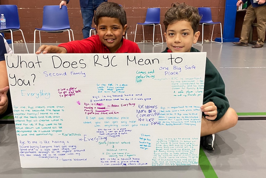 Children hold a sign that reads 'What Does RYC Mean To You?'  at the National Center for Indigenous Excellence in Redfern 