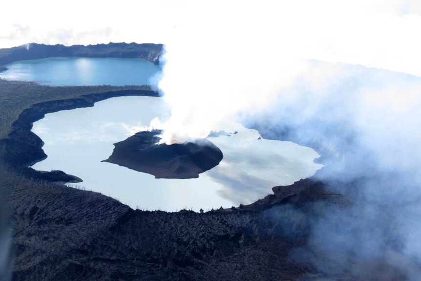 Steam rises from the volcanic cone that is surrounded by Lake Vui