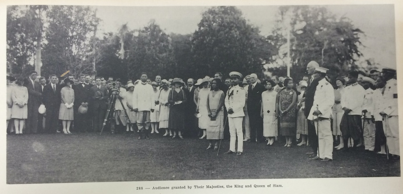 Black and white photos of students on a lawn in Thailand meeting the King of Siam in a formal white uniform.