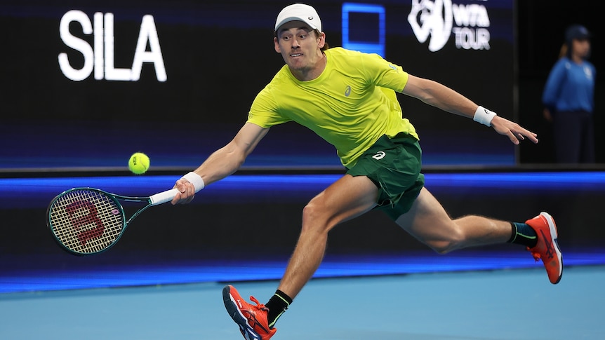 Alex de Minaur stretches for a forehand return in the United Cup.