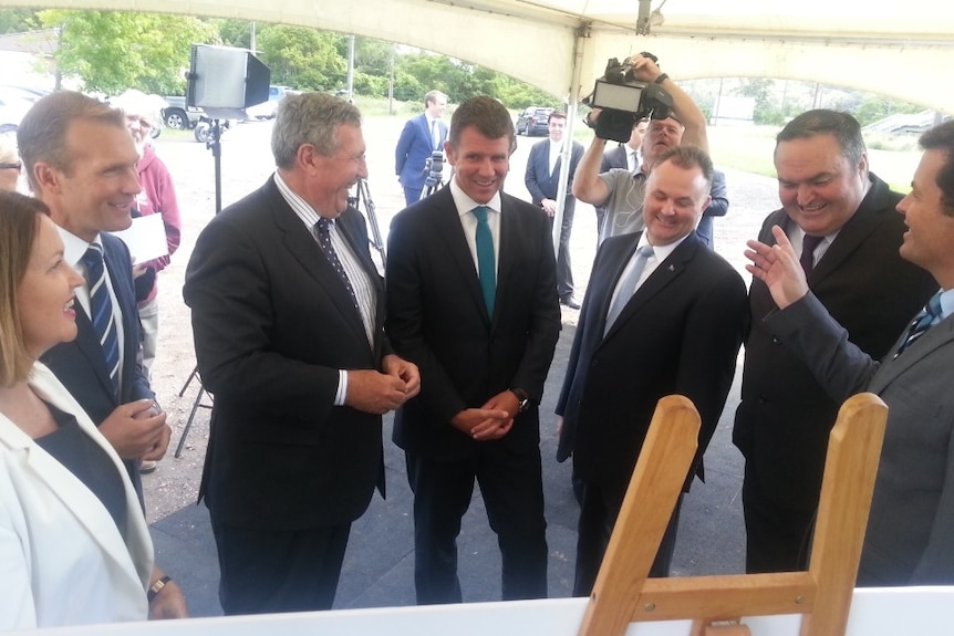 The New South Premier, Mike Baird (centre) making the $100 million road funding commitment at Ourimbah.