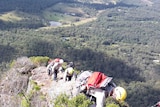 Queensland Fire rescuers climb a trail on Mt Beerwah, in the Glasshouse Mountains