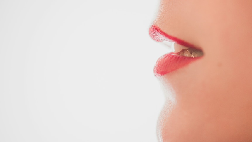 a close up image of a lip with red lipstick