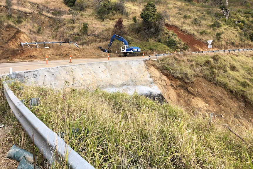 A landslip site with concrete and rods sticking out of it.