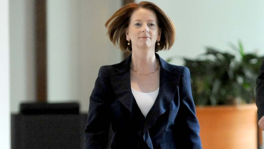 Prime Minister Julia Gillard walks the corridors of Parliament House
