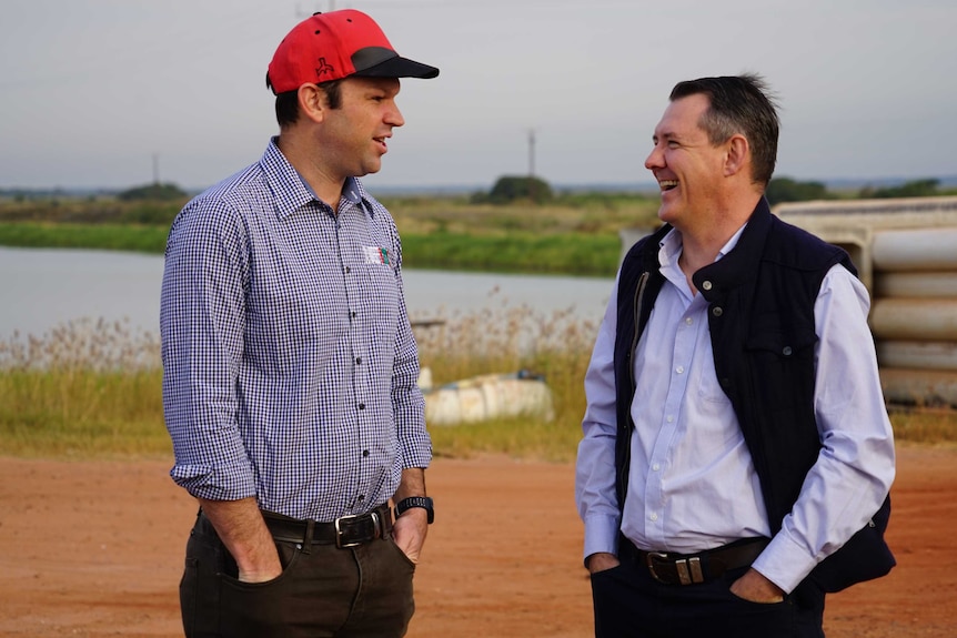 Senator Matt Canavan and Chief Minister Michael Gunner stand by a Barramundi pond.