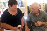 Olga and Graham McLeod sitting together, drinking tea.