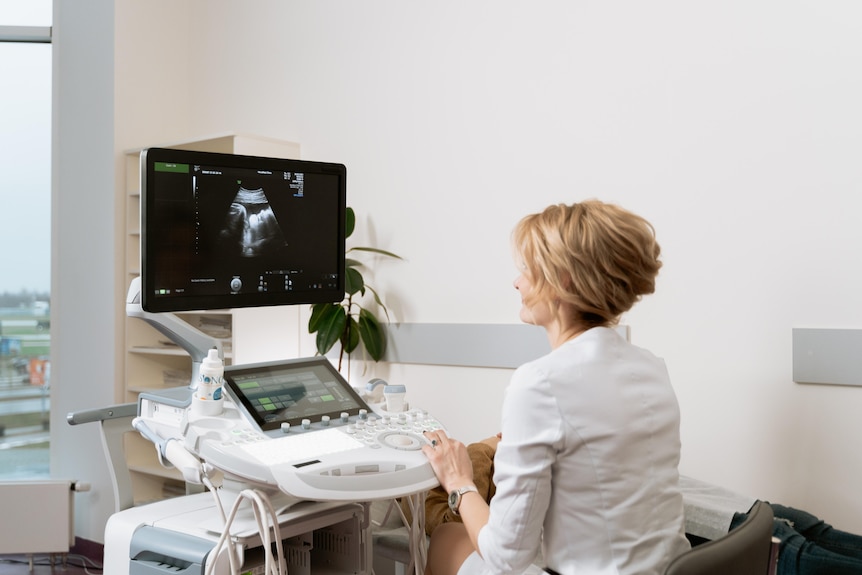 An unidentified doctor looks at a sonogram.