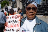 Beatrice Mushiya outside the gates at the Houses of Parliament