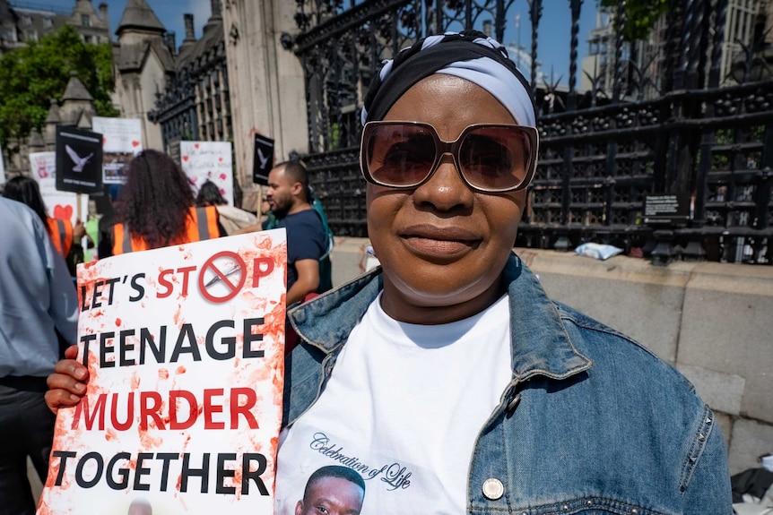 Beatrice Mushiya outside the gates at the Houses of Parliament