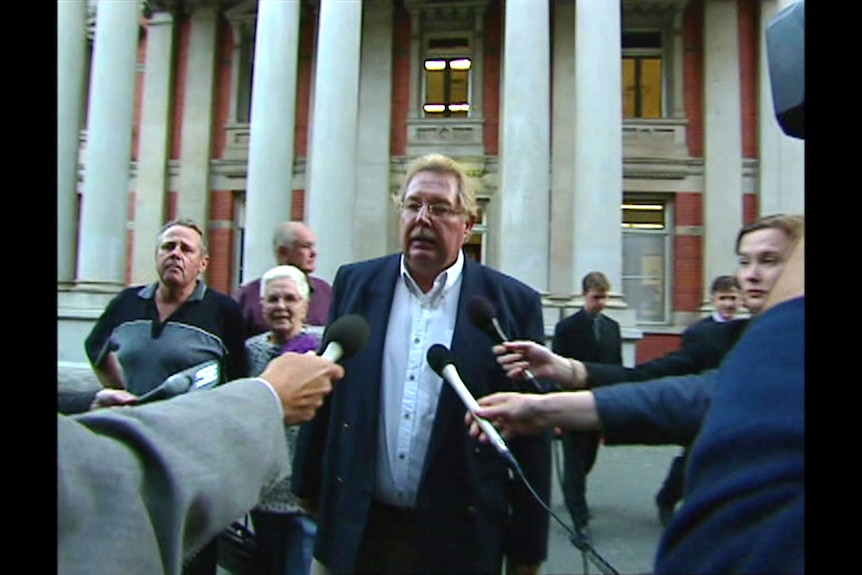 A man outside the WA Supreme Court surounded by journalists.