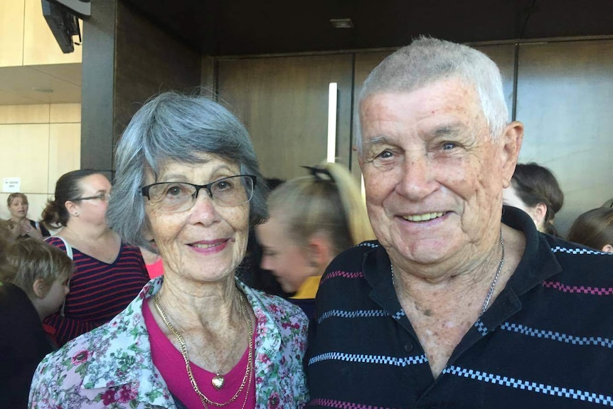 A woman and a man smile at the camera