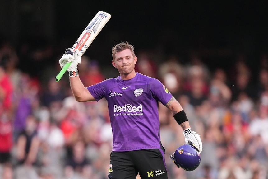 Batter raises his bat after scoring 100 runs in the BBL.