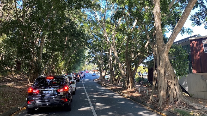 Cars lining up on a bitumen driveway