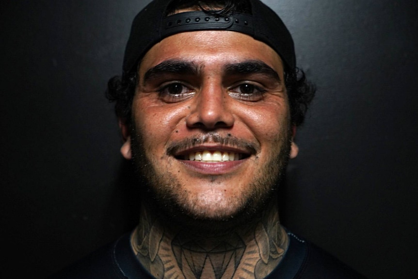 Man close up big grin, tattoos