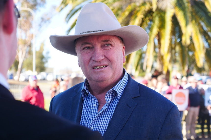 A close up of a man wearing a hat