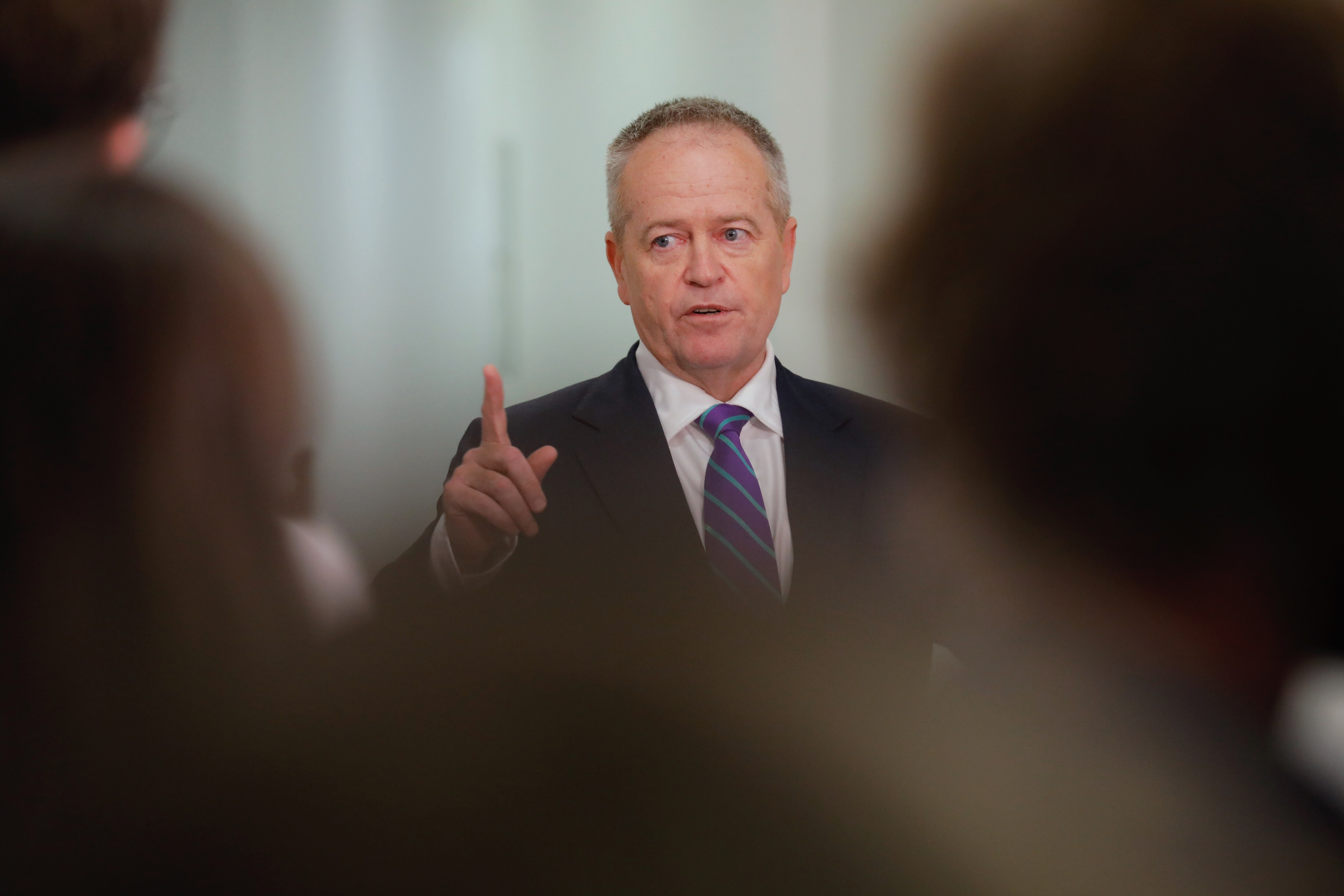 Shorten holds an index finger up as he talks.