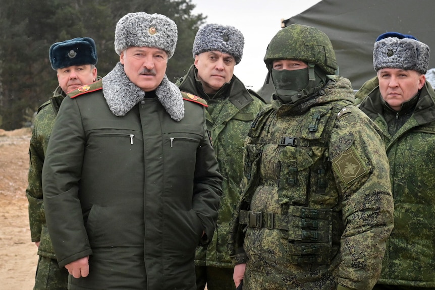 Alexander Lukashenko, second left, Alexander Volfovich, centre, and Viktor Khrenin, right, at a training ground in Belarus