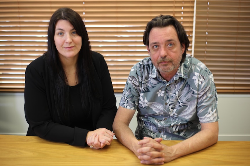 Ms Adair-La and Mr Harrison sitting at a desk.