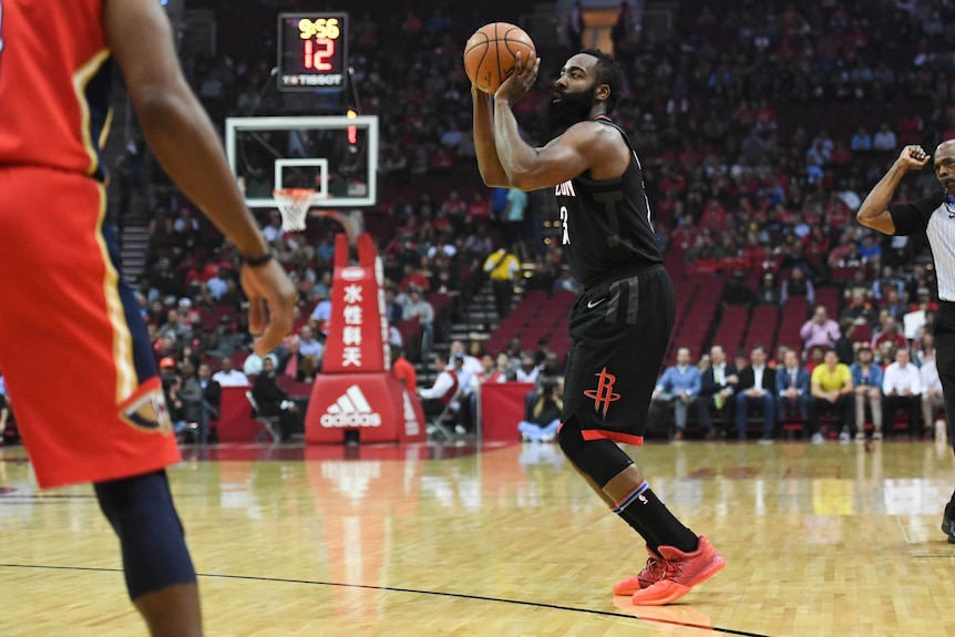 Houston Rockets guard James Harden (13) shoots a three-pointer during the first quarter against the New Orleans Pelicans