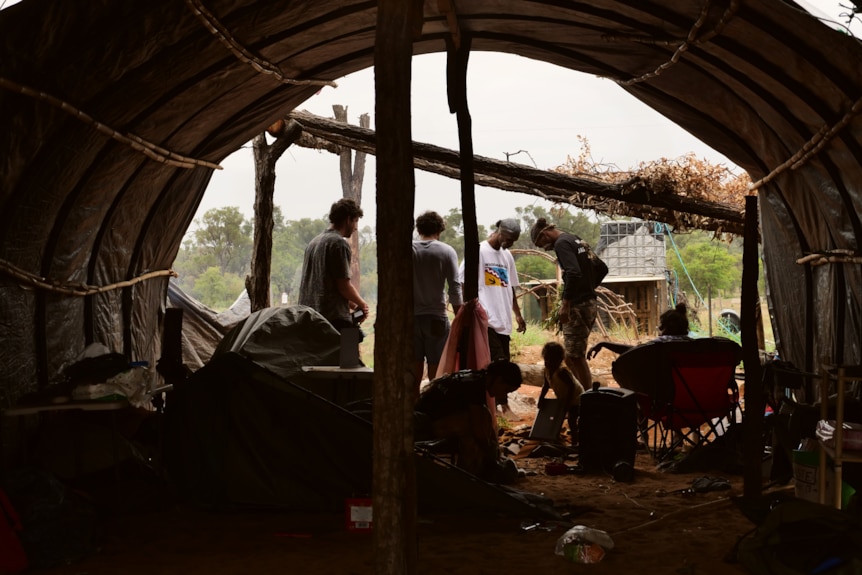  a sheltered communal area which leads into a fire and smoking ceremony area on a patch of grassy land