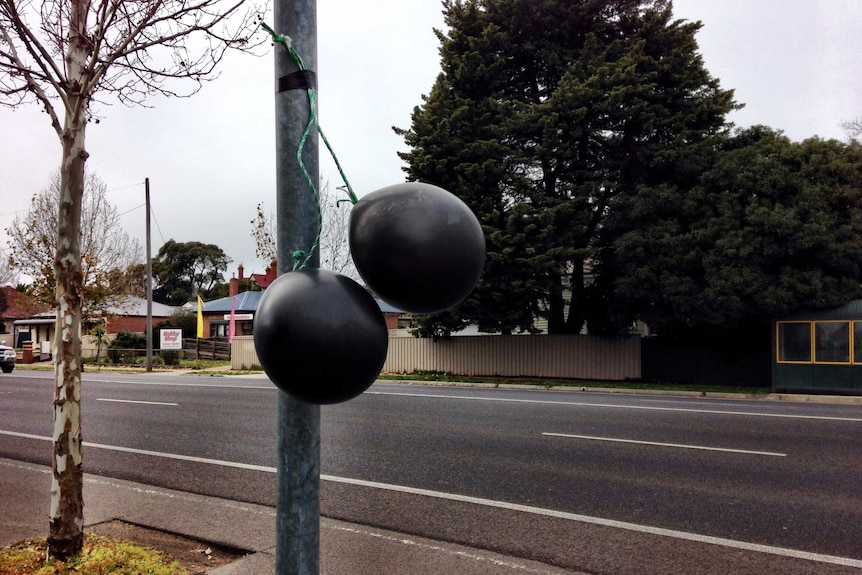 Black balloons hanging in the streets of Bendigo to oppose plans to build a mosque