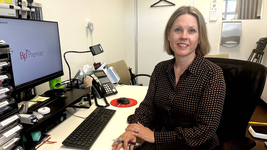 An Adelaide GP sits at her desk.