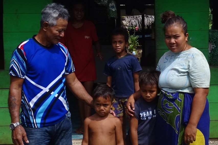 Eseta Meki with her family outside their home near Apia