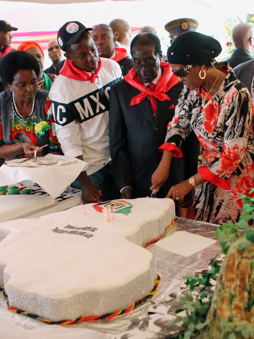 Zimbabwe president Robert Mugabe cuts his 91st birthday cake