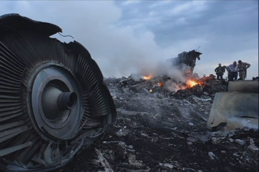 Plane wreckage including flaming material and smashed turbine
