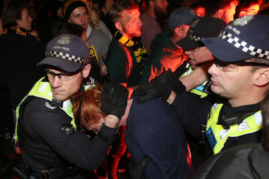 police move into a crowd of Richmond fans.