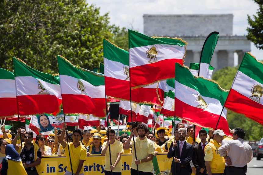 Activists march in Washington D.C. with Shah-era Iranian flags to call for regime change in Iran.
