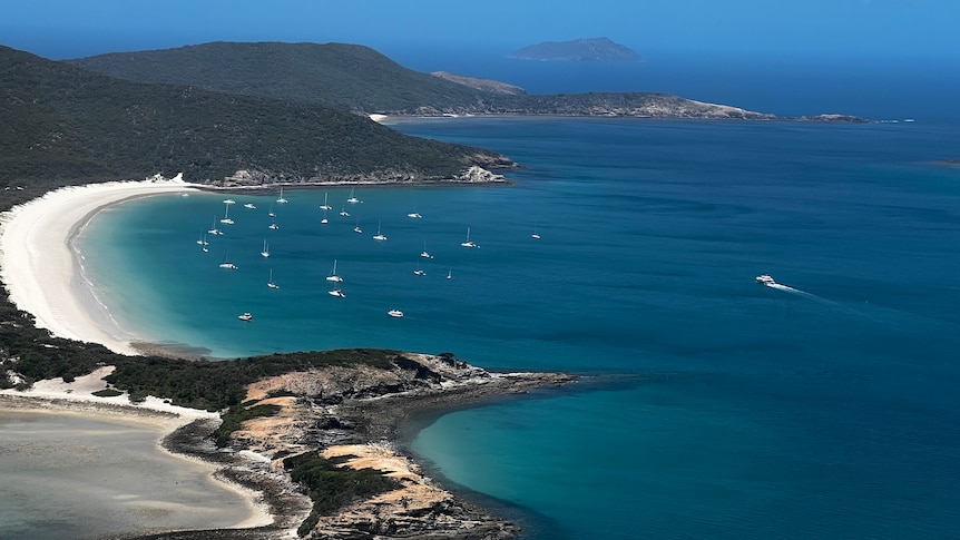 An aerial view of a beach on an island in the tropics