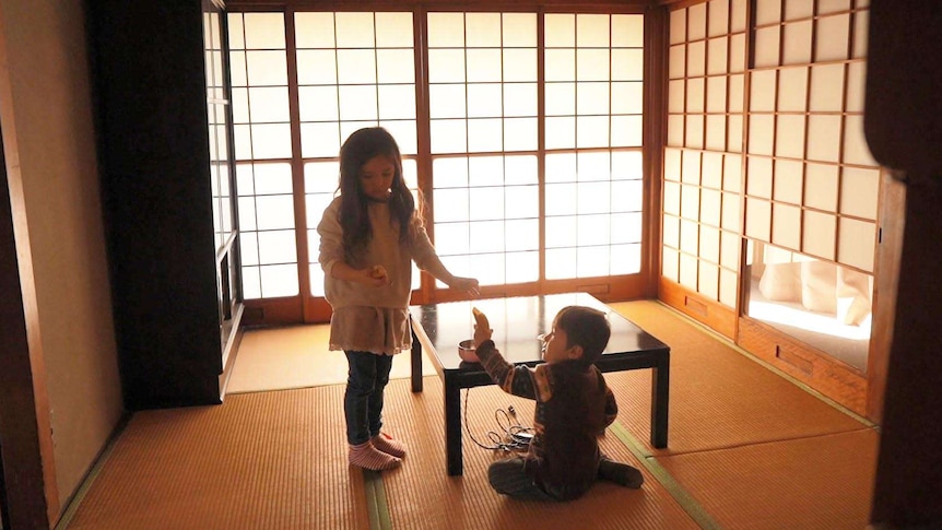 Juna and Remy Stuart playing in their house in Japan for a story about travelling the world as a family