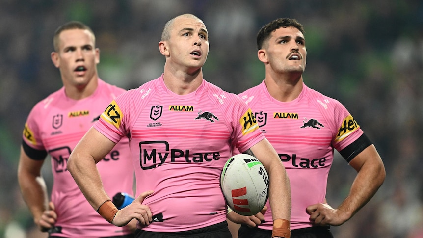 A group of rugby league players look on during a match